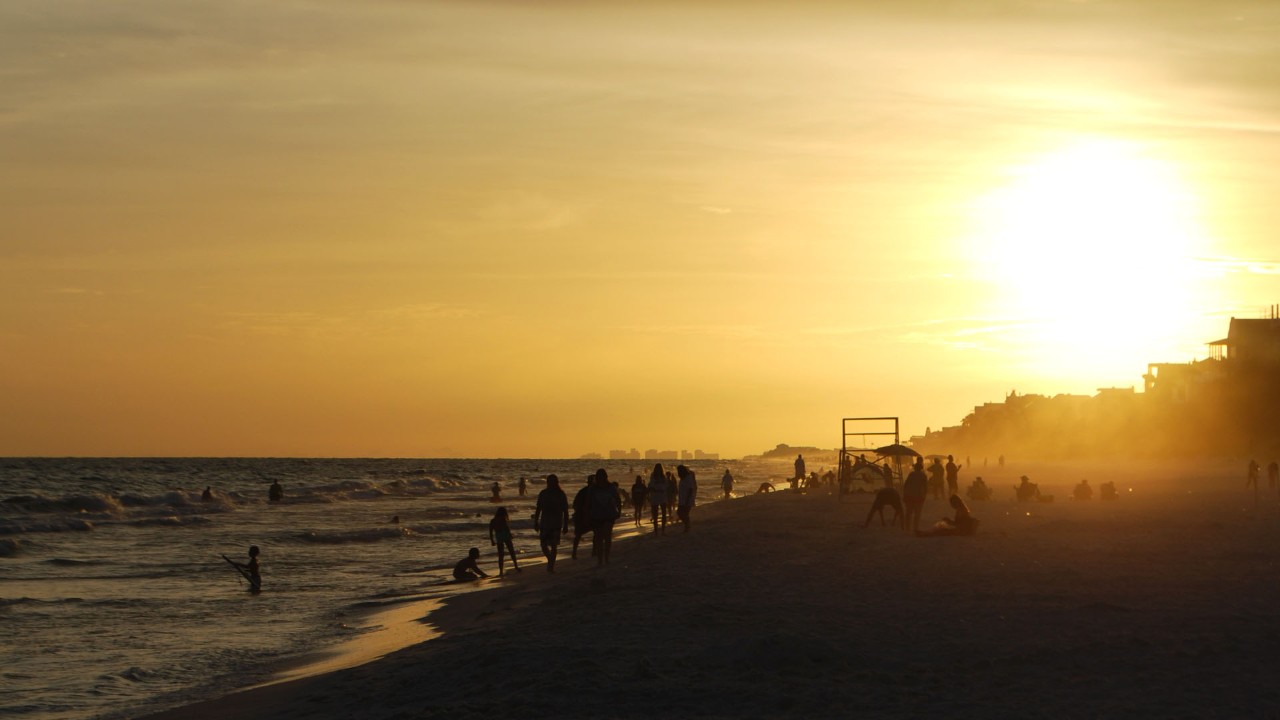 Families gather to watch the sun set at Fort Walton Beach.