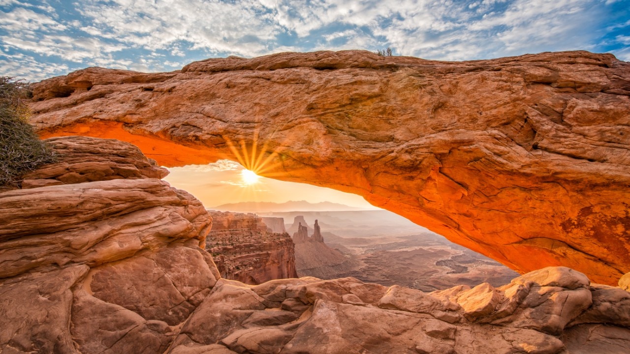 The morning sunlight illuminates Mesa Arch in Canyonlands National Park.