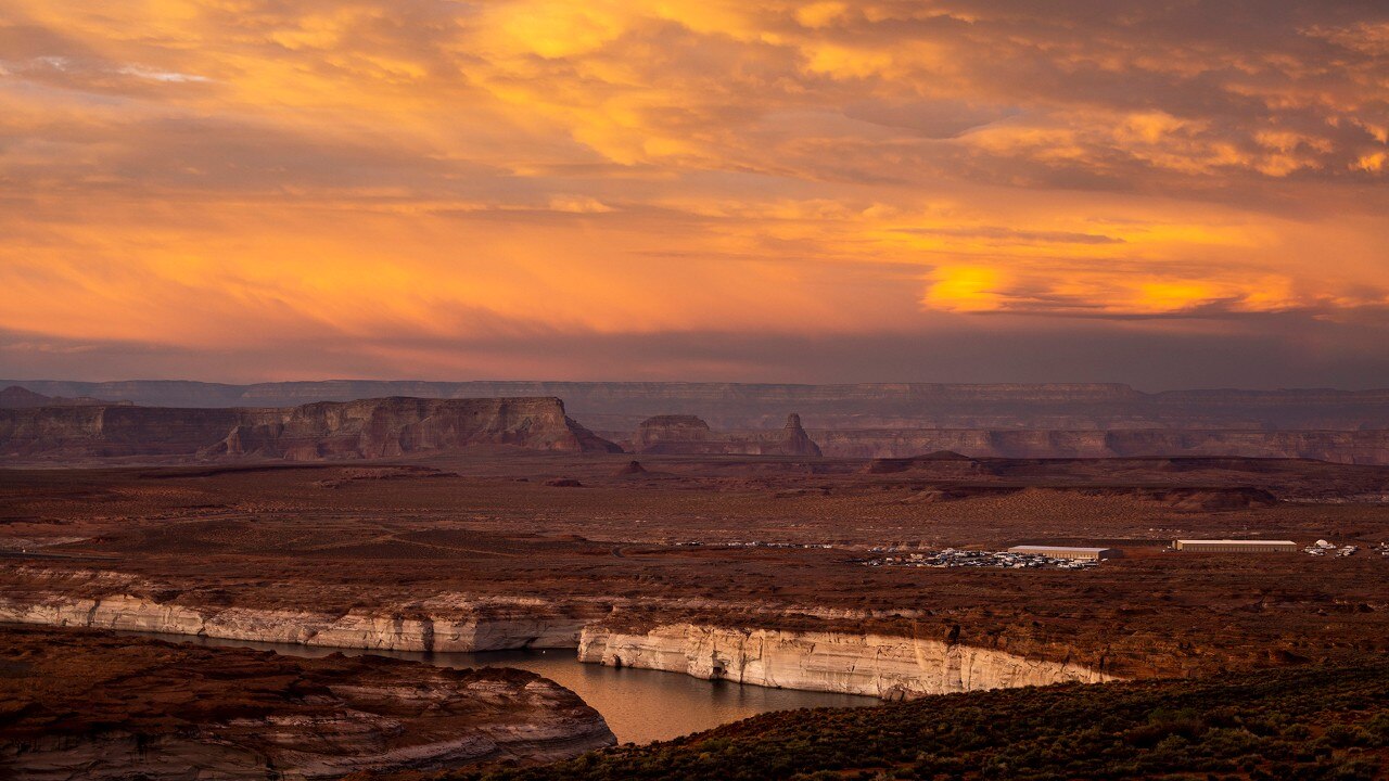 The sunset lights up Lake Powell and Antelope Point Marina as seen from Grandview Overlook.
